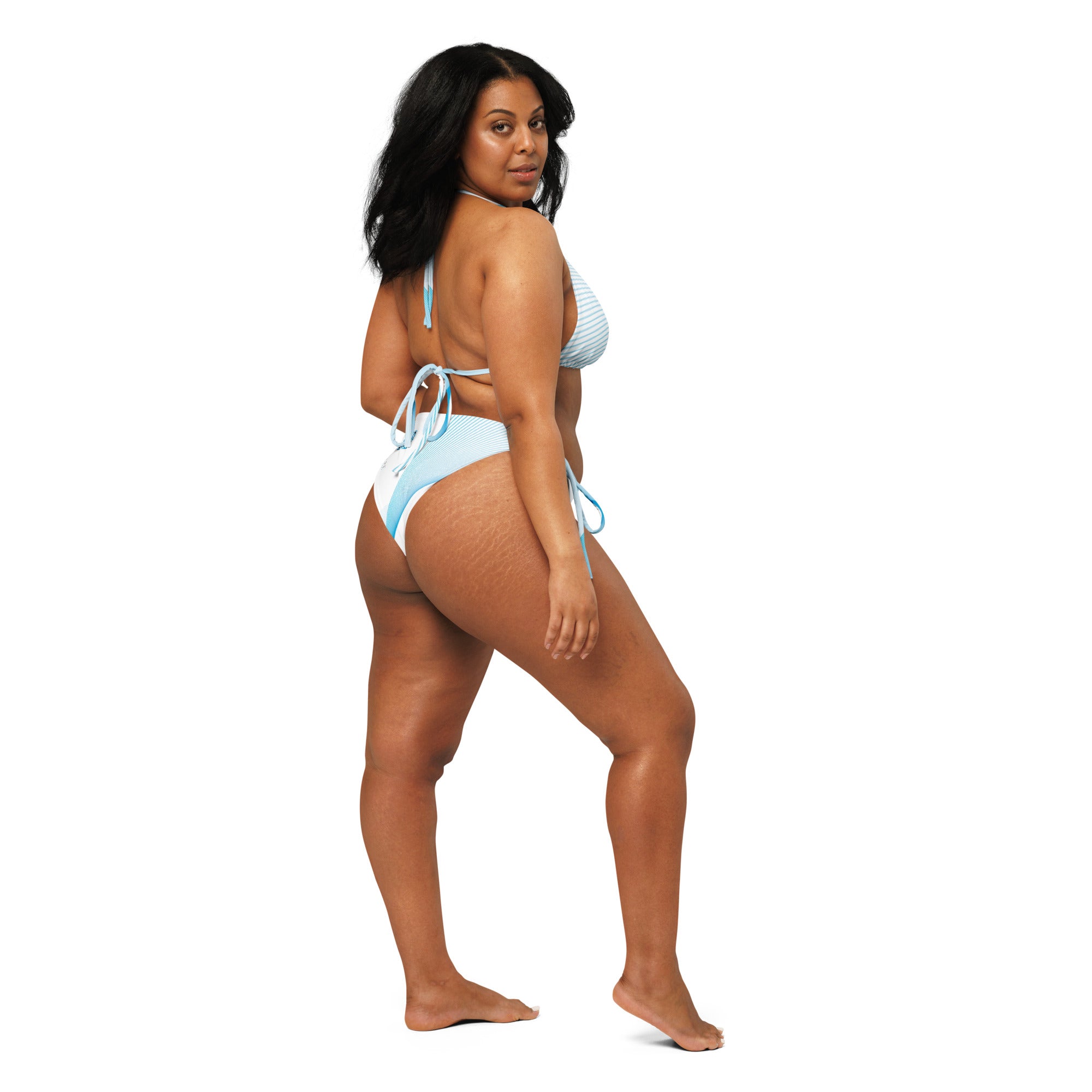 Side view of sexy African American woman modeling the Create The Atmosphere themed Bikini on a white background.