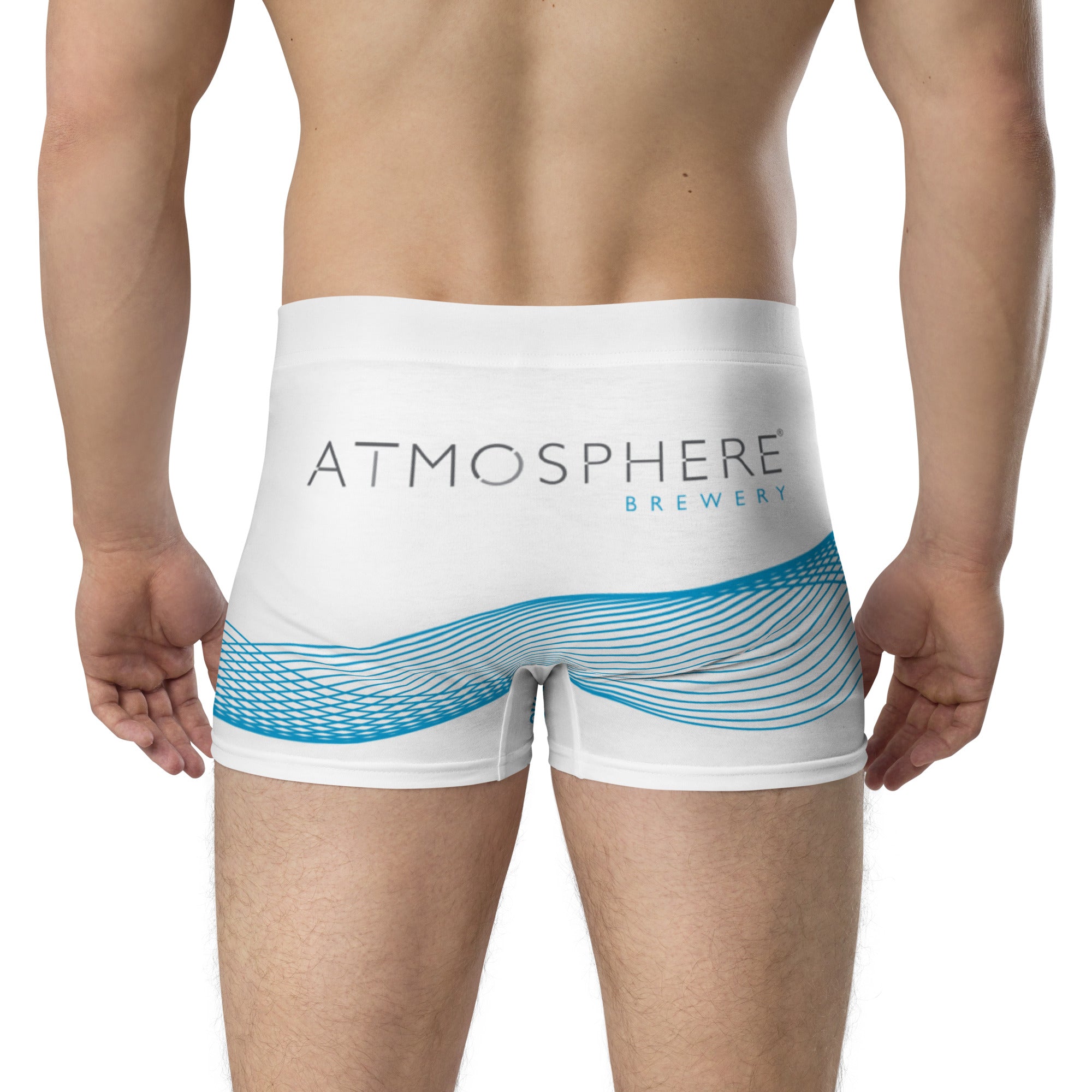 Back of white mens swim trunks depicting the Atmosphere logo with blue stripes around the legs worn by an athletic man.